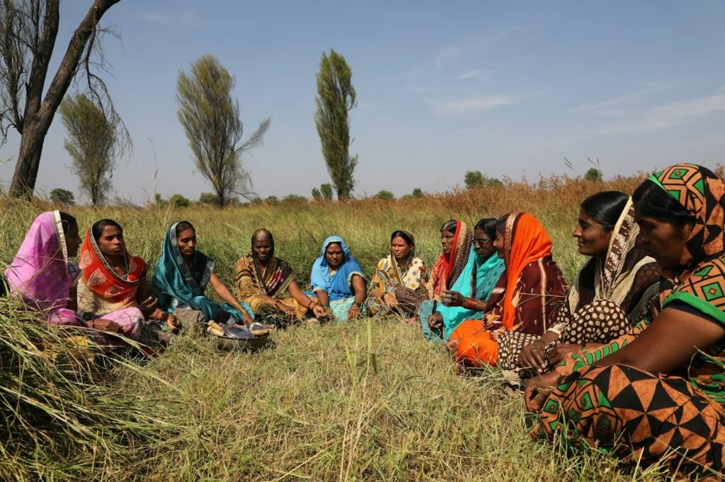People sitting together on a grass field